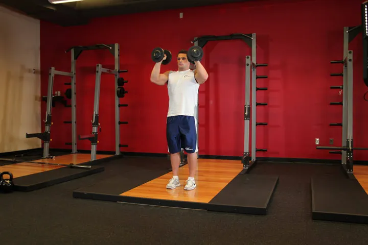 Standing Palms-In Dumbbell Press — contração